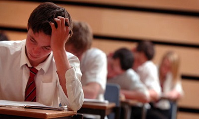 Pupils sit exams in a school hall