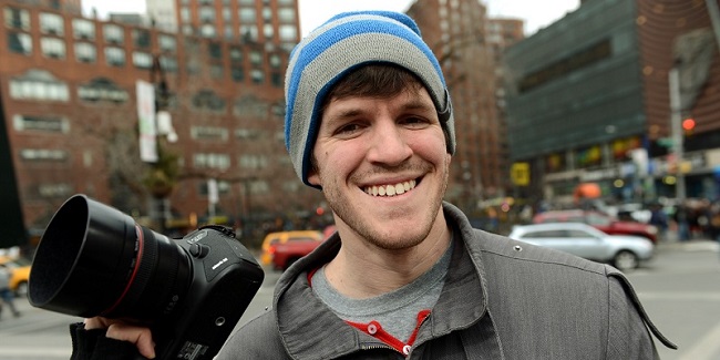 Brandon Stanton, creator of the Humans of New York blog, with his camera February 22, 2013 across the street from Union Square in New York. Some like New York's skyscrapers, bridges, his energy, taxis or lights. But Brandon Stanton has set himself another challenge: photograph of 10,000 inhabitants for a blog now famous "Humans of New York."  In two years, he has photographed 5,000 New Yorkers, children leaving school, tramps, fashionistas, New York with a bouquet of tulips, old lady with a cane, municipal employees, etc. And nearly 560,000 fans now follow his Facebook page.AFP PHOTO/Stan HONDA        (Photo credit should read STAN HONDA/AFP/Getty Images)