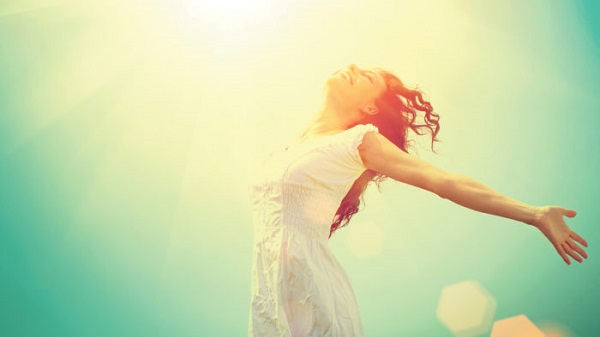 Free Happy Woman Enjoying Nature. Beauty Girl Outdoor. Freedom concept. Beauty Girl over Sky and Sun. Sunbeams. Enjoyment.