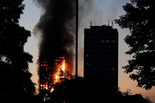 Flames and smoke billow as firefighters deal with a serious fire in a tower block at Latimer Road in West London, Britain June 14, 2017. REUTERS/Toby Melville